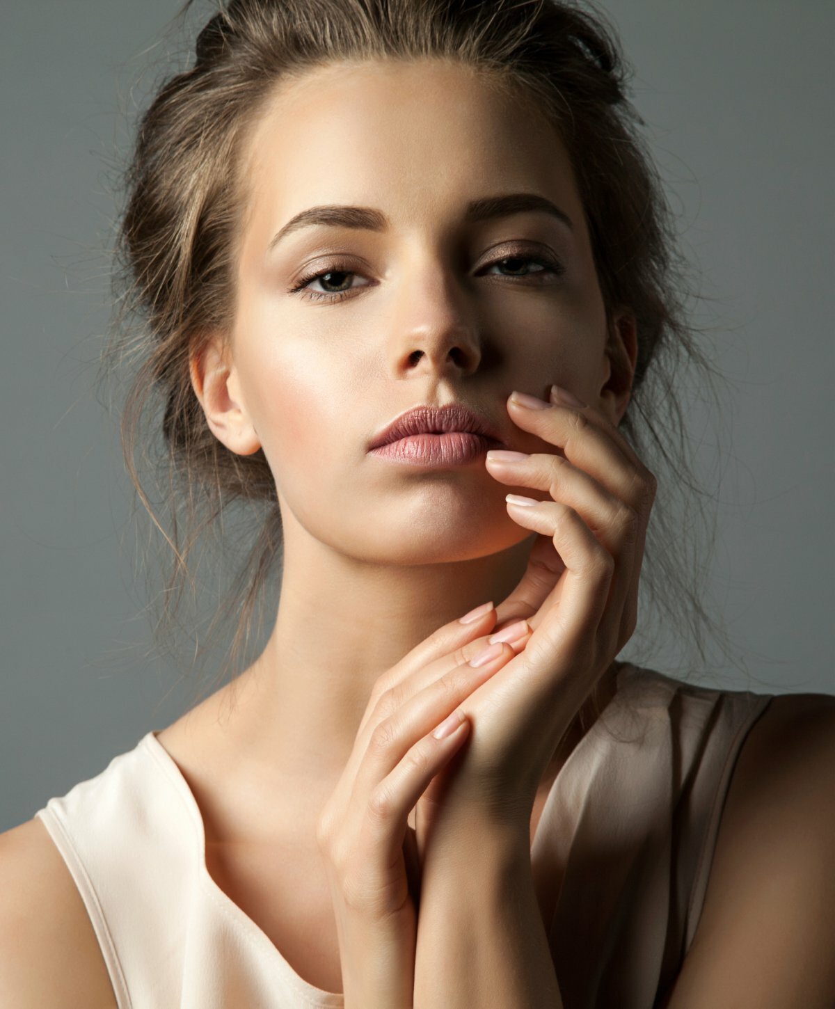 New York botox model touching face
